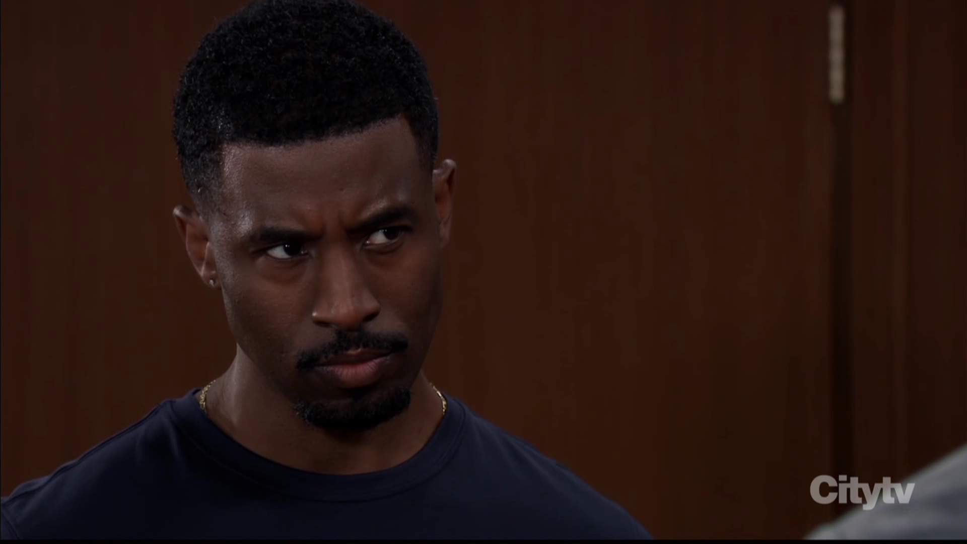 Zeke handsome and looking upset at Curtis for telling the truth