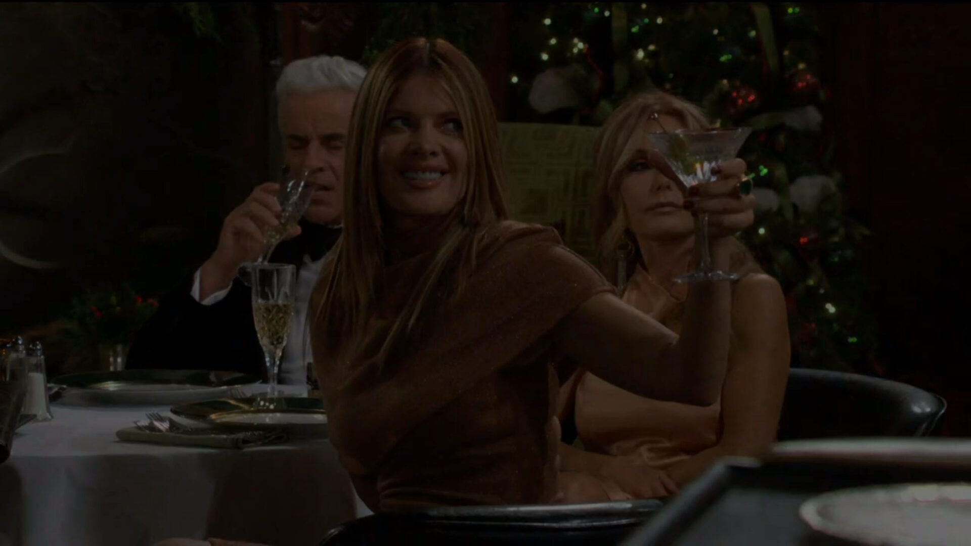 phyllis lifts a glass to danny
